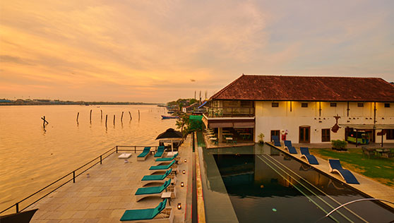Sunset view of the harbour and heritage boutique hotel Fortkochi India
